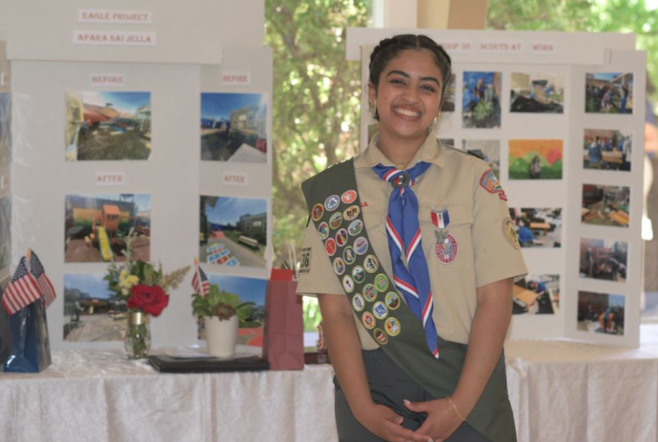 Apara S standing in front of a display showing pictures of her Eagle Scout service project.